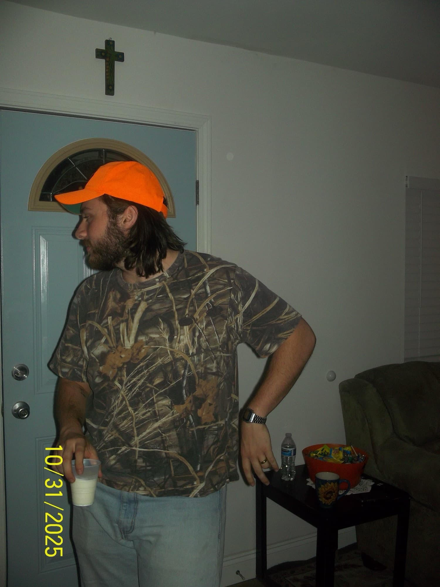 Colby in a blaze-orange cap and camo tee at a Halloween party